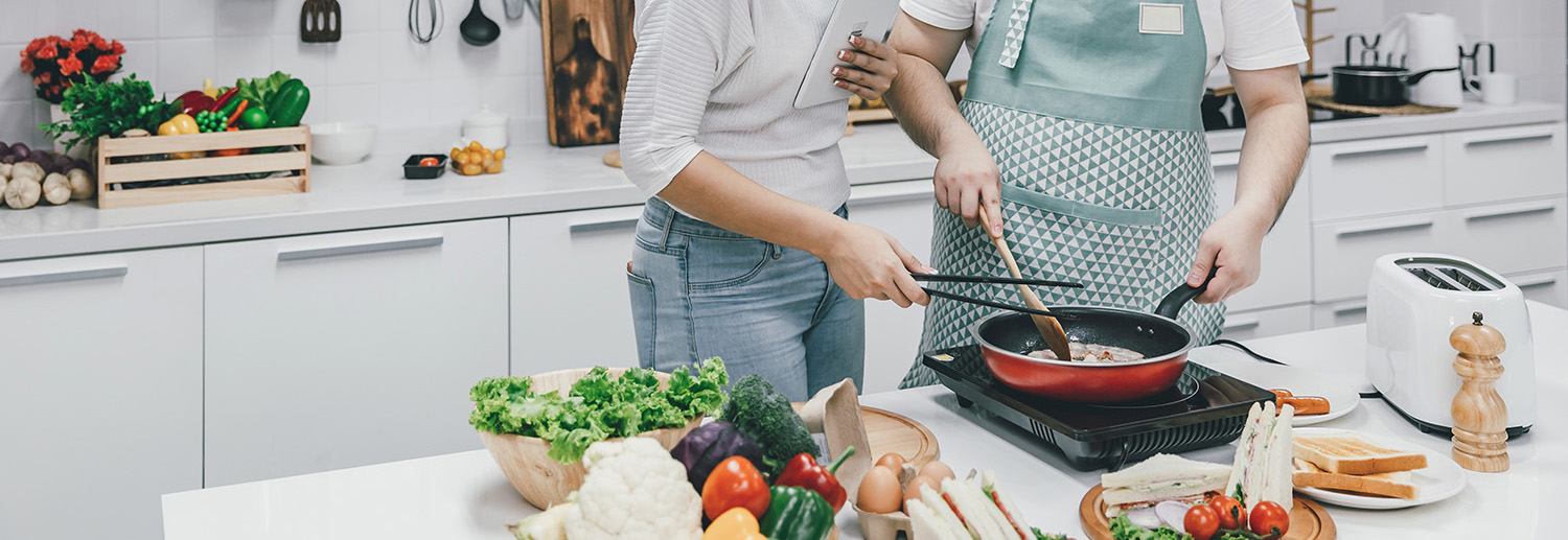 couple cooking, following a recipe